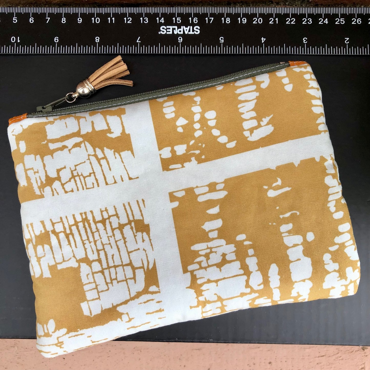 Mustard Yellow Abstract lined zipper pouch with tassel