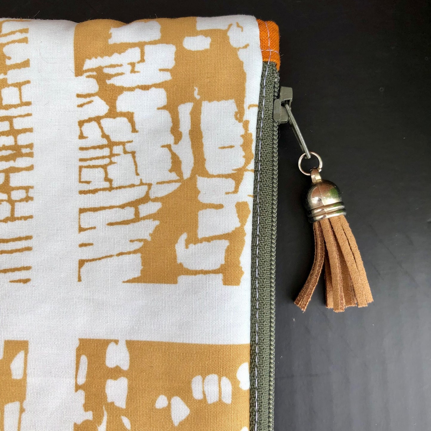 Mustard Yellow Abstract lined zipper pouch with tassel